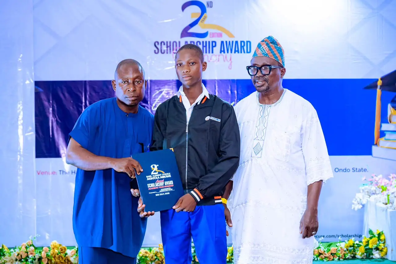 Honoring academic excellence: A scholar is presented with his merit scholarship award.
